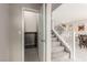 Hallway with a stairway, closed storage space under the stairs, and tile flooring at 6909 Toll Mountain St, North Las Vegas, NV 89086