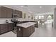 Modern kitchen featuring stainless steel appliances, island, and an adjacent dining area with large windows at 6909 Toll Mountain St, North Las Vegas, NV 89086
