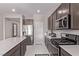 Bright kitchen featuring stainless steel appliances, white countertops, and dark brown cabinets at 6909 Toll Mountain St, North Las Vegas, NV 89086
