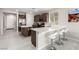 Stylish kitchen features stainless steel appliances, a center island, and a breakfast bar with modern white bar stools at 6909 Toll Mountain St, North Las Vegas, NV 89086