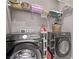 Laundry room featuring front loading washer and dryer with shelving at 6909 Toll Mountain St, North Las Vegas, NV 89086