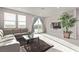 Bright living room with a comfortable sofa, large windows, and a glass sliding door to the outside at 6909 Toll Mountain St, North Las Vegas, NV 89086
