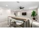 Open living space including a sofa, high-top table with bar stools and a media center at 6909 Toll Mountain St, North Las Vegas, NV 89086