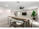 Open living space including a sofa, high-top table with bar stools and a media center at 6909 Toll Mountain St, North Las Vegas, NV 89086