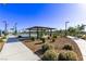 Park featuring picnic tables under a shaded shelter, with lush landscaping and walking paths at 6909 Toll Mountain St, North Las Vegas, NV 89086