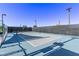 Outdoor tennis court with net and fencing, offering a space for recreational activities at 6909 Toll Mountain St, North Las Vegas, NV 89086