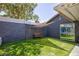 Backyard featuring a bench, artificial turf, shade, and a sliding glass door entrance at 6924 Senton Ave, Las Vegas, NV 89108