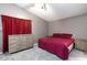 This bedroom features a cozy red comforter set and matching wood furniture set at 6924 Senton Ave, Las Vegas, NV 89108