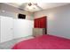The bedroom is equipped with a spacious closet, ceiling fan, and mounted TV at 6924 Senton Ave, Las Vegas, NV 89108