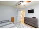 Cozy bedroom features a ceiling fan, TV, area rug, and doorway to another room at 6924 Senton Ave, Las Vegas, NV 89108