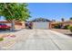 Charming single-story home featuring a two-car garage, desert landscaping, and a mature shade tree at 6924 Senton Ave, Las Vegas, NV 89108
