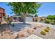 Charming single-story home featuring a two-car garage, desert landscaping, and a mature shade tree at 6924 Senton Ave, Las Vegas, NV 89108