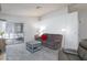 Comfortable living room with gray sofa, textured carpet, and sliding glass doors to backyard at 6924 Senton Ave, Las Vegas, NV 89108