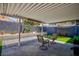 Covered patio featuring stylish outdoor seating, desert landscaping, and access to the yard at 6924 Senton Ave, Las Vegas, NV 89108