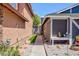 Side yard featuring a walkway, decorative landscaping, a seating area, and access to the backyard at 6924 Senton Ave, Las Vegas, NV 89108