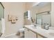 Bathroom with double sinks, framed mirror, and tiled shower at 7559 Chambery Cove Ct, Las Vegas, NV 89123