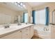 Bathroom features double sinks, large mirror, and separate tub and shower at 7559 Chambery Cove Ct, Las Vegas, NV 89123