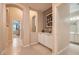 Neutral hallway with tiled floor, arched entryways, and cabinet space at 7559 Chambery Cove Ct, Las Vegas, NV 89123