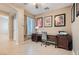 Cozy home office featuring a classic wooden desk, comfortable chair, and natural lighting at 7559 Chambery Cove Ct, Las Vegas, NV 89123