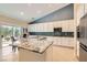 Stylish kitchen with granite countertops, white cabinets, and a sliding glass door to the patio at 7559 Chambery Cove Ct, Las Vegas, NV 89123