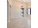 Open-concept living space with tile floors, high ceilings, and a stylish chandelier at 7559 Chambery Cove Ct, Las Vegas, NV 89123