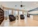 Bright living room features tile floor, ceiling fan, with backyard access at 7559 Chambery Cove Ct, Las Vegas, NV 89123
