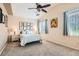 Cozy main bedroom with ceiling fan, large windows, and neutral decor at 7559 Chambery Cove Ct, Las Vegas, NV 89123