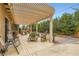 Relaxing outdoor patio with a pergola, stylish furniture, and well-maintained landscaping at 7559 Chambery Cove Ct, Las Vegas, NV 89123