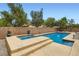 A refreshing pool and spa are surrounded by lush landscaping and privacy walls at 7559 Chambery Cove Ct, Las Vegas, NV 89123