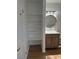 Bathroom with wood vanity, sink, mirror and shelving at 7885 W Flamingo Rd # 2129, Las Vegas, NV 89147