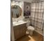 Cozy bathroom featuring stylish vanity, toilet, and tiled shower with curtain at 7885 W Flamingo Rd # 2129, Las Vegas, NV 89147