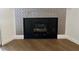 Close up of a modern fireplace with decorative tile and contemporary design elements at 7885 W Flamingo Rd # 2129, Las Vegas, NV 89147