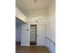 Bright hallway featuring modern light fixture, coat closet, and clean white walls at 7885 W Flamingo Rd # 2129, Las Vegas, NV 89147