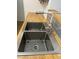 Stainless steel double basin sink with modern faucet and wooden countertop at 7885 W Flamingo Rd # 2129, Las Vegas, NV 89147
