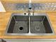 Double basin stainless steel sink with modern faucet and butcher block countertop at 7885 W Flamingo Rd # 2129, Las Vegas, NV 89147