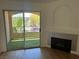 Living room opens to balcony, enhancing light and views, plus a cozy fireplace at 7885 W Flamingo Rd # 2129, Las Vegas, NV 89147