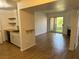 Open-concept living room leading to a patio, complemented by wood floors and white walls at 7885 W Flamingo Rd # 2129, Las Vegas, NV 89147