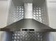 Modern stainless steel range hood with decorative backsplash in a renovated kitchen at 7885 W Flamingo Rd # 2129, Las Vegas, NV 89147