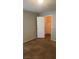 Bedroom featuring neutral carpet, a closet, and a door with a brushed metal handle at 8101 W Flamingo Rd # 2110, Las Vegas, NV 89147