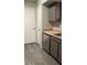 Kitchen features gray cabinets, stainless steel dishwasher, and vinyl floor at 8101 W Flamingo Rd # 2110, Las Vegas, NV 89147