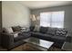 Bright living room with a large sectional sofa and a modern glass coffee table at 8101 W Flamingo Rd # 2110, Las Vegas, NV 89147