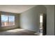 Neutral living room with a front door and large window that provides natural light at 8101 W Flamingo Rd # 2110, Las Vegas, NV 89147
