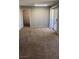 Living room featuring a sliding glass door with outdoor access and neutral carpet at 8101 W Flamingo Rd # 2110, Las Vegas, NV 89147
