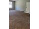 Spacious living room with neutral carpet, bright window, and a white front door at 8101 W Flamingo Rd # 2110, Las Vegas, NV 89147