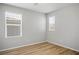 Simple bedroom featuring two windows providing natural light and wood-look flooring at 9136 Cocowoods Pl, Las Vegas, NV 89148