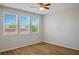 Bright bedroom featuring wood-look floors and a large window with natural light at 9136 Cocowoods Pl, Las Vegas, NV 89148