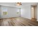 Spacious bedroom with wood flooring, a ceiling fan, and two windows at 9136 Cocowoods Pl, Las Vegas, NV 89148
