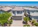 Stylish two-story home showcases desert landscaping and an inviting exterior at 9136 Cocowoods Pl, Las Vegas, NV 89148