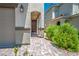 Inviting front entrance featuring a covered walkway with stone columns and paver flooring at 9136 Cocowoods Pl, Las Vegas, NV 89148