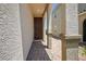 Inviting front entrance featuring a covered walkway with stone columns and paver flooring at 9136 Cocowoods Pl, Las Vegas, NV 89148
